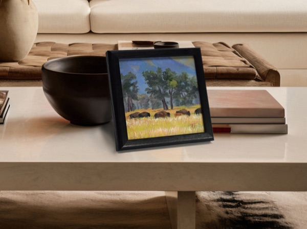 Bison Beneath Shadow Mountain displayed on a coffee table in a warm, neutral living room